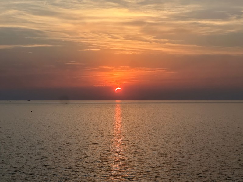 The partially eclipsed Sun setting over the Mediterranean from the north of Corsica at 20:22 CEST, 12 August 2026